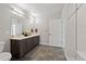 Modern bathroom features a double vanity, sleek tile flooring, and recessed lighting at 20 Wilcox St # 312, Castle Rock, CO 80104