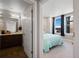 Bedroom with large windows and an ensuite bathroom featuring double sinks at 20 Wilcox St # 312, Castle Rock, CO 80104