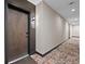Building hallway with carpet, showing apartment entry doors at 20 Wilcox St # 312, Castle Rock, CO 80104