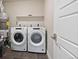Bright laundry room with side-by-side washer and dryer, and open shelving at 20 Wilcox St # 312, Castle Rock, CO 80104