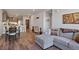 Open living room featuring hardwood floors, modern sectional sofa, and adjacent dining area at 20 Wilcox St # 312, Castle Rock, CO 80104