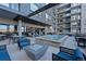 Outdoor patio area with a hot tub, lounge chairs, and seating at 20 Wilcox St # 312, Castle Rock, CO 80104
