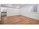 Finished basement area with hardwood flooring and stylish bathroom with white cabinetry and modern fixtures at 9007 E 60Th Ave, Denver, CO 80238