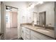 Bathroom with double sinks, modern fixtures, and an entrance to the bedroom at 9007 E 60Th Ave, Denver, CO 80238