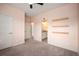 Light-filled bedroom with light pink walls and a bathroom entrance at 9007 E 60Th Ave, Denver, CO 80238