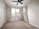 Cozy bedroom featuring a ceiling fan, natural light, and a closet for ample storage at 9007 E 60Th Ave, Denver, CO 80238