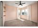 Bright bedroom featuring large windows and neutral carpet at 9007 E 60Th Ave, Denver, CO 80238