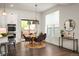 Cozy dining area with modern lighting, adjacent to the kitchen and featuring a sliding door to the exterior at 9007 E 60Th Ave, Denver, CO 80238