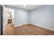A bright empty room with wood floors, ready for your design ideas, with an adjoining bathroom at 9007 E 60Th Ave, Denver, CO 80238
