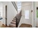 Bright entryway features an staircase, coat hooks, hardwood floors, and natural light from windows at 9007 E 60Th Ave, Denver, CO 80238