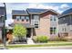 Beautiful two-story home featuring solar panels, landscaping, and a welcoming front entrance at 9007 E 60Th Ave, Denver, CO 80238