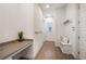 Hallway boasts hardwood floors, a built-in desk, hooks, a bench, and ample storage space at 9007 E 60Th Ave, Denver, CO 80238