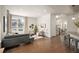 Open-concept living area with hardwood floors, contemporary decor, and seamless flow into the kitchen at 9007 E 60Th Ave, Denver, CO 80238