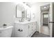 Bathroom featuring dual sinks, tiled floors, marble tile shower, and neutral paint at 740 Moline St, Aurora, CO 80010