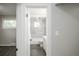 Bathroom featuring tiled shower and a glimpse into the carpeted bedroom at 740 Moline St, Aurora, CO 80010