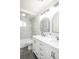 Bathroom featuring dual sinks, tiled walls and flooring, and neutral paint at 740 Moline St, Aurora, CO 80010