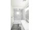 Bathroom featuring a shower-tub combo with marble tile and a round ceiling light at 740 Moline St, Aurora, CO 80010