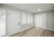 This bright bedroom features three windows dressed with blinds and wood-look floors at 740 Moline St, Aurora, CO 80010