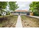 Charming ranch-style home with a well-maintained front yard and a driveway leading to the garage at 740 Moline St, Aurora, CO 80010
