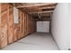 Unfinished garage with concrete floors, wood studs and open ceiling at 740 Moline St, Aurora, CO 80010