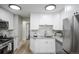 Well-lit kitchen featuring granite countertops, stainless steel appliances, and white cabinetry at 740 Moline St, Aurora, CO 80010