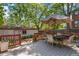 A charming back deck with outdoor seating under a large umbrella, surrounded by lush greenery at 1226 Clayton St, Denver, CO 80206