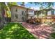 Expansive backyard featuring lush green grass, mature trees, brick patio and outdoor deck at 1226 Clayton St, Denver, CO 80206