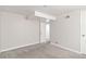 Finished basement with neutral walls and carpet and an adjoining room at 1226 Clayton St, Denver, CO 80206