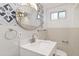 Bright bathroom featuring vanity with marble countertop, oval mirror, and decorative wall tiles at 1226 Clayton St, Denver, CO 80206