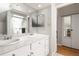 Neutral bathroom featuring double sinks, large mirrors, and a walk-in shower at 1226 Clayton St, Denver, CO 80206