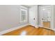 Bright bedroom features hardwood flooring, neutral paint, and white trim, creating a serene space at 1226 Clayton St, Denver, CO 80206