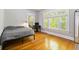 Bedroom with windows and hardwood floors, offering natural light and a view of the outdoors at 1226 Clayton St, Denver, CO 80206