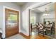 Elegant dining room featuring a chandelier, hardwood floors, and a large window at 1226 Clayton St, Denver, CO 80206