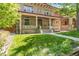 Charming home with a manicured lawn, inviting front porch, and classic architectural details at 1226 Clayton St, Denver, CO 80206