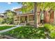 Home with covered porch, mature trees, and well-maintained lawn at 1226 Clayton St, Denver, CO 80206
