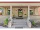 Inviting front porch with lion statues, columns, and space for relaxing in the shade at 1226 Clayton St, Denver, CO 80206