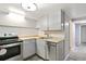 This kitchen features stainless steel appliances, light gray cabinetry, and wood countertops at 1226 Clayton St, Denver, CO 80206