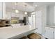 Bright kitchen featuring white cabinets, stainless steel appliances, and a breakfast bar at 1226 Clayton St, Denver, CO 80206