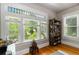 Bright living room featuring detailed windows offering natural light and a view of lush greenery at 1226 Clayton St, Denver, CO 80206
