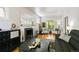 Spacious living room featuring hardwood floors, a fireplace, and lots of natural light at 1226 Clayton St, Denver, CO 80206