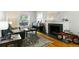 Bright living room with a decorative fireplace, stylish furniture, and hardwood floors at 1226 Clayton St, Denver, CO 80206