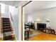 View into cozy living room featuring a fireplace and stairs to the upper level at 1226 Clayton St, Denver, CO 80206