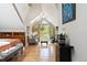 Sunlit main bedroom features a vaulted ceiling, a private balcony, and gleaming hardwood floors at 1226 Clayton St, Denver, CO 80206