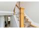 Beautiful carpeted staircase featuring a decorative wooden banister leading to the upper level at 1226 Clayton St, Denver, CO 80206
