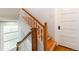 Staircase with natural wood treads and white risers, enhanced by elegant wooden banisters at 1226 Clayton St, Denver, CO 80206