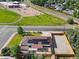 Aerial view of home with solar panels on roof, large fenced yard, and view of a park and school at 7380 Utica St, Westminster, CO 80030
