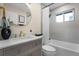 Elegant bathroom with a modern vanity, round mirror, and a shower-tub combination at 7380 Utica St, Westminster, CO 80030