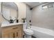 Bathroom with new fixtures, a tiled shower, and wood-styled cabinets at 7380 Utica St, Westminster, CO 80030