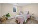 Cozy bedroom features a garden view and a pink decorative motif at 7380 Utica St, Westminster, CO 80030