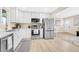 Modern kitchen with white cabinets, stainless steel appliances, and ample counter space for cooking at 7380 Utica St, Westminster, CO 80030